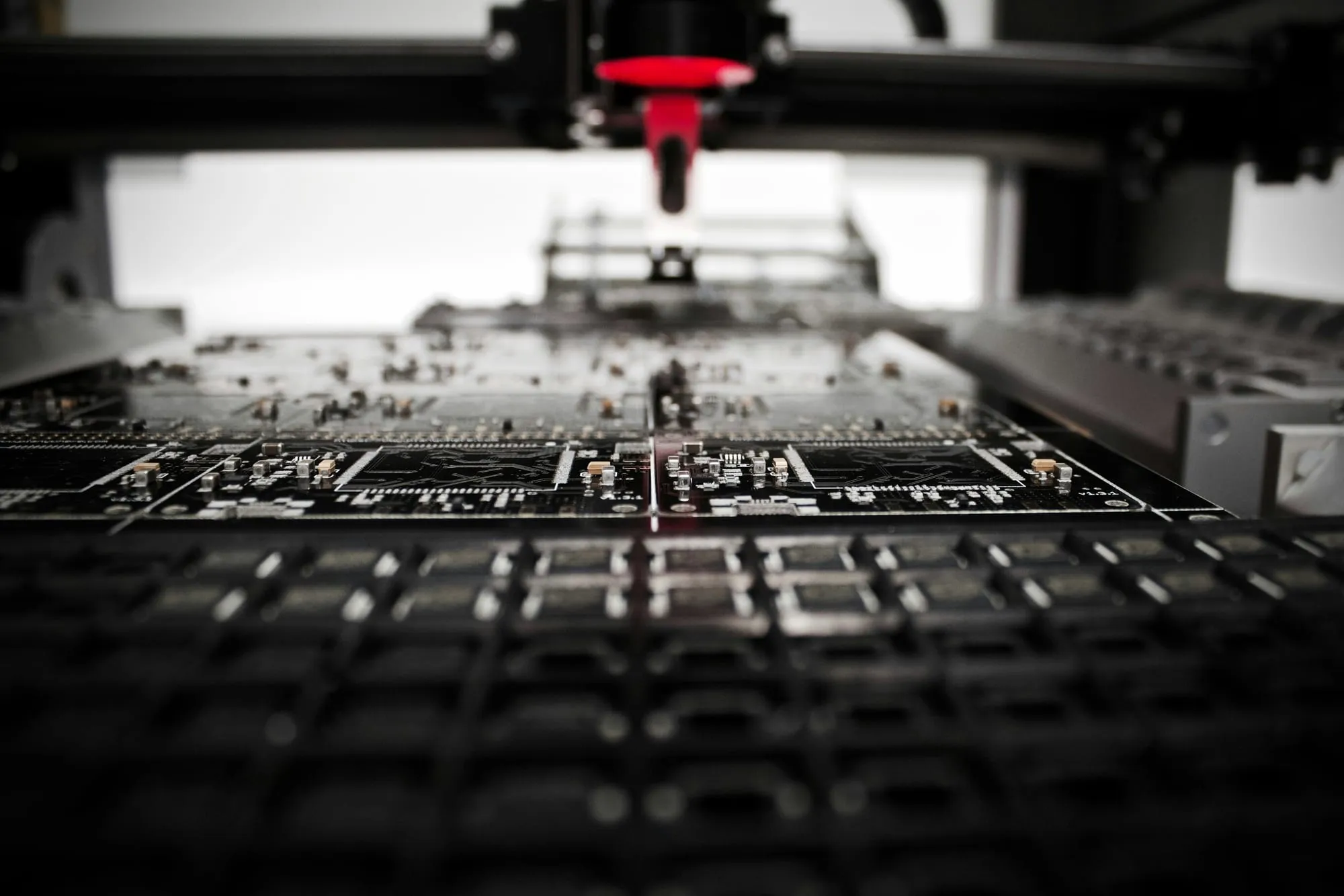 A pick-and-place machine head over a printed circuit board